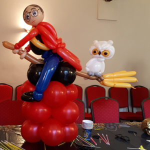 Harry Potter on broomstick balloon with owl balloon